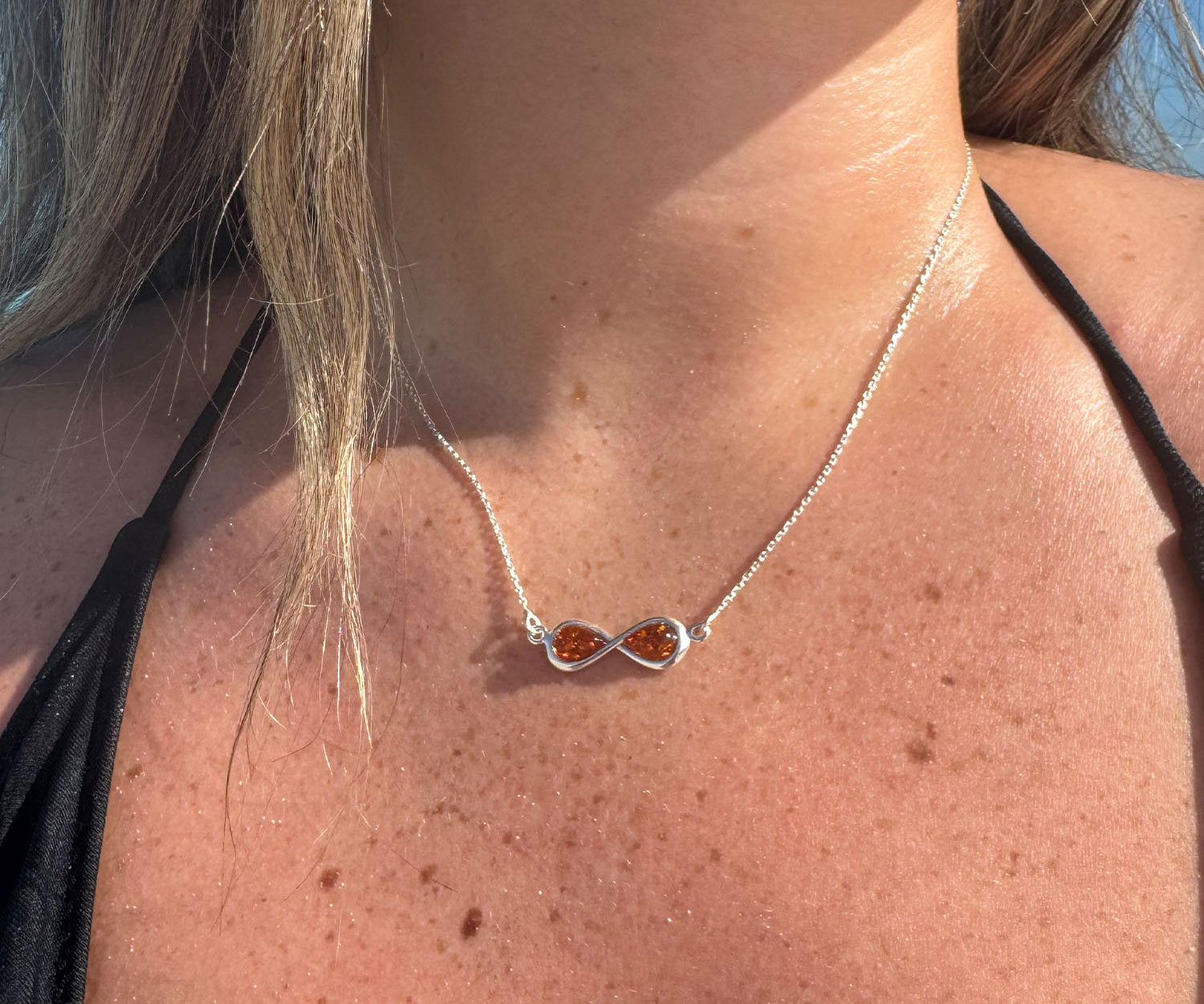 Infinity Charm Necklace – handcrafted in Baltic amber and sterling silver
