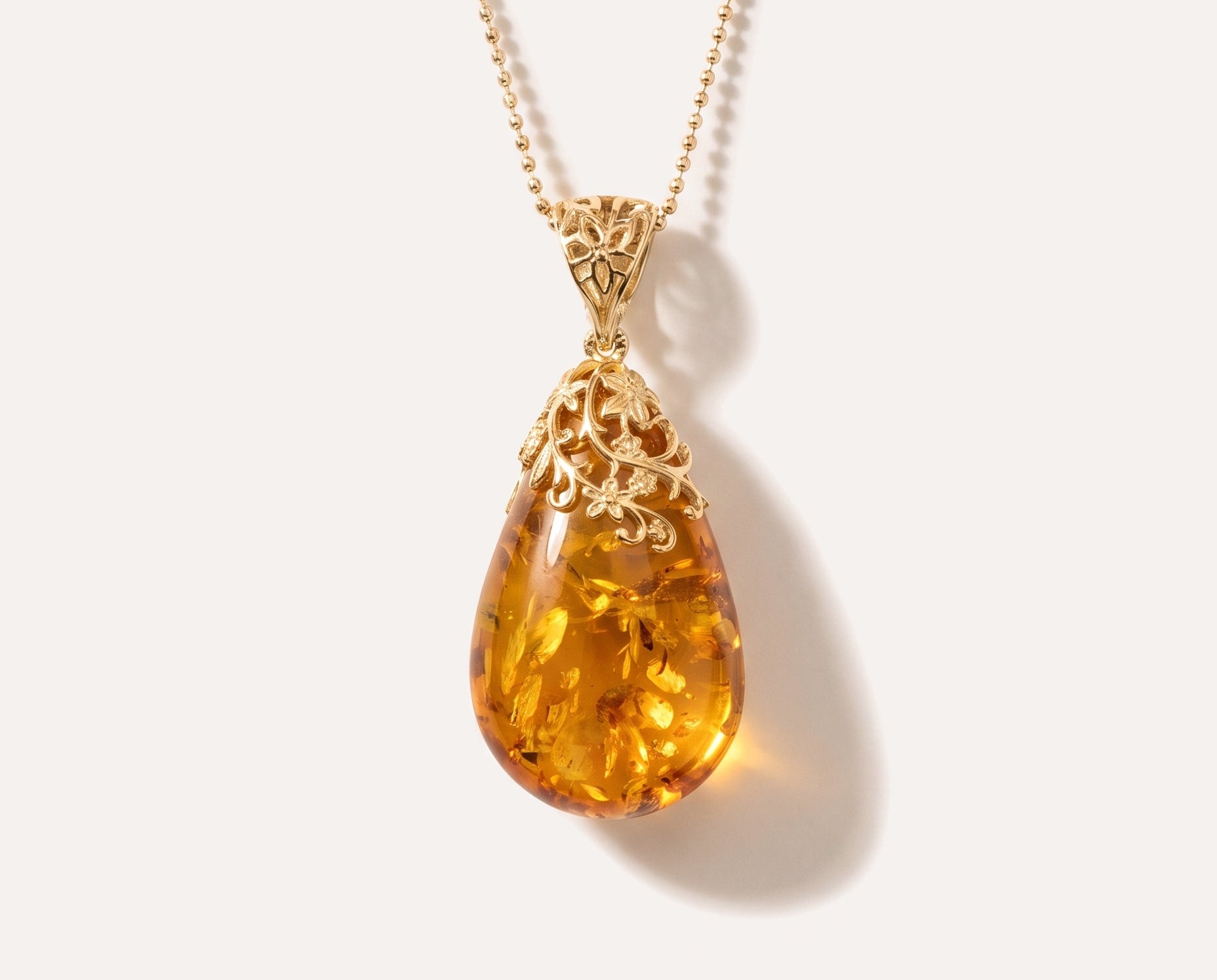 Gold Floral Accent Amber Droplet Pendant — Baltic amber and sterling silver jewellery by Baltic Beauty