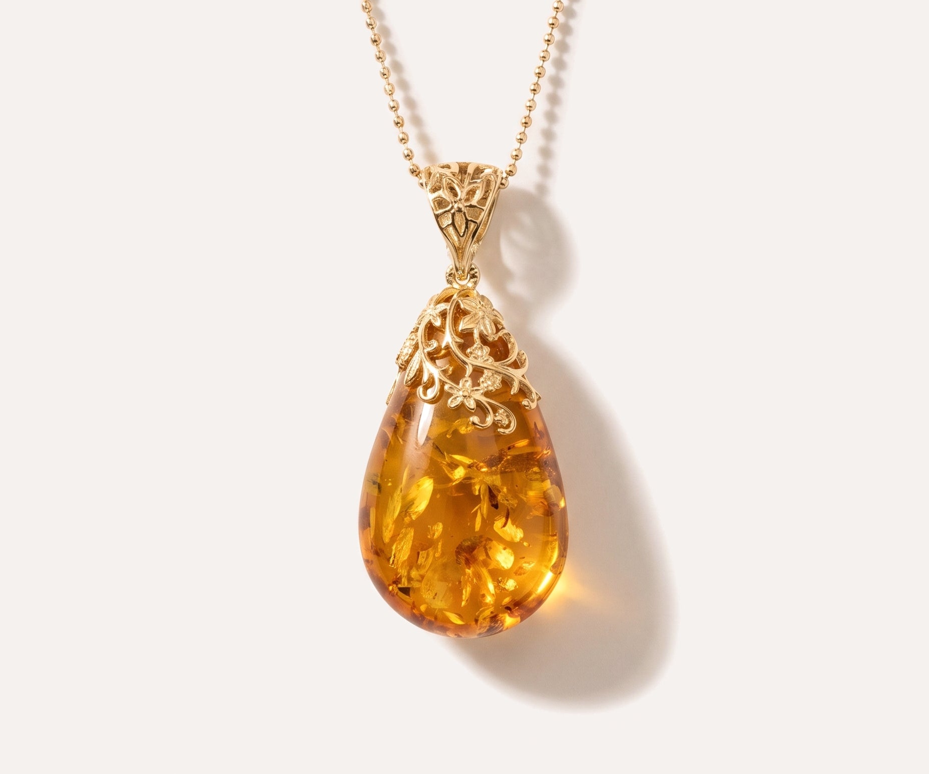 Gold Floral Accent Amber Droplet Pendant — Baltic amber and sterling silver jewellery by Baltic Beauty